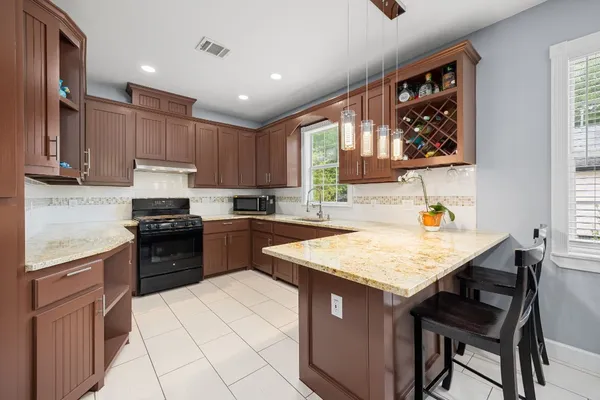 a kitchen with a sink stove and cabinets