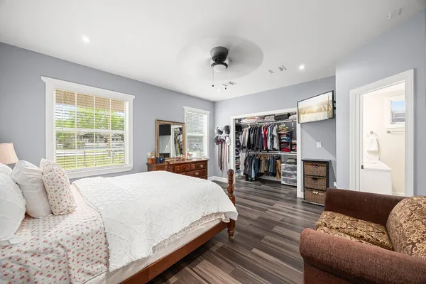 a bedroom with a bed and wooden floor