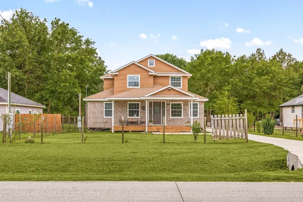 a front view of a house with a garden