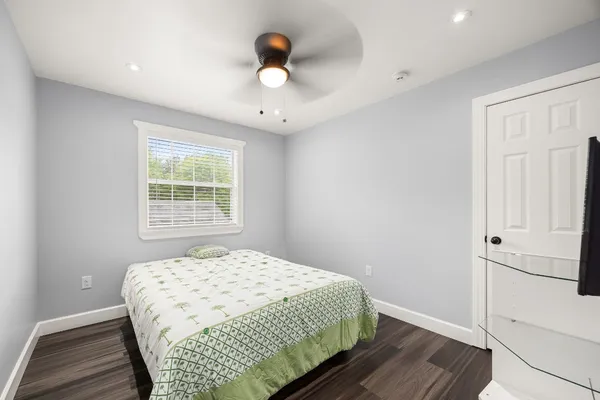 a view of living room with furniture and floor to ceiling fan