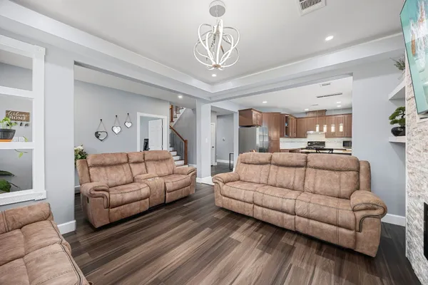 a kitchen with granite countertop a stove top oven cabinetry and garage