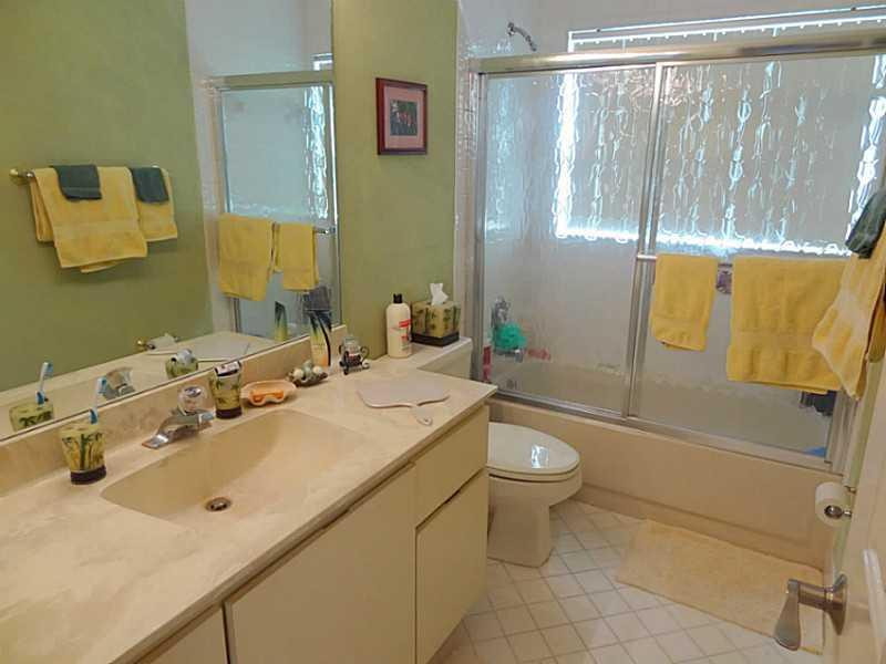 22338 Ensenada Way Boca Raton, FL 33433 - Photo 14 of 20 a bathroom with a sink a toilet and shower