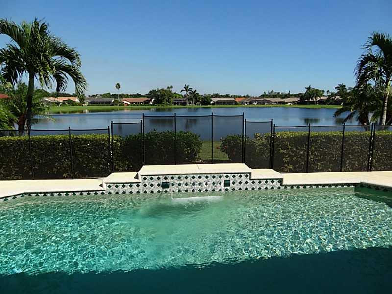 22338 Ensenada Way Boca Raton, FL 33433 - Photo 16 of 20 a view of a lake with a building in the background