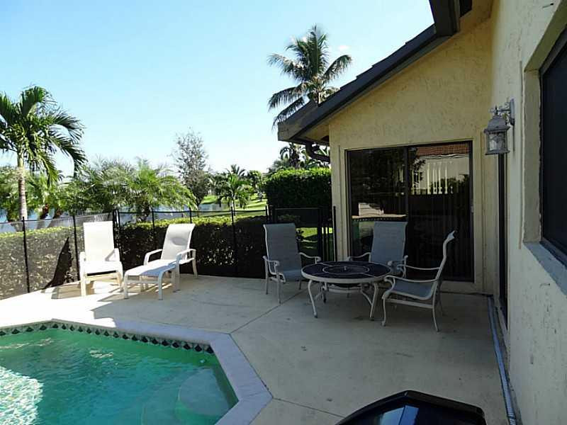 22338 Ensenada Way Boca Raton, FL 33433 - Photo 17 of 20 a view of a patio with a table and chairs
