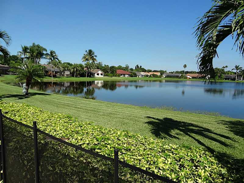 22338 Ensenada Way Boca Raton, FL 33433 - Photo 20 of 20 a view of a lake with a house in the background