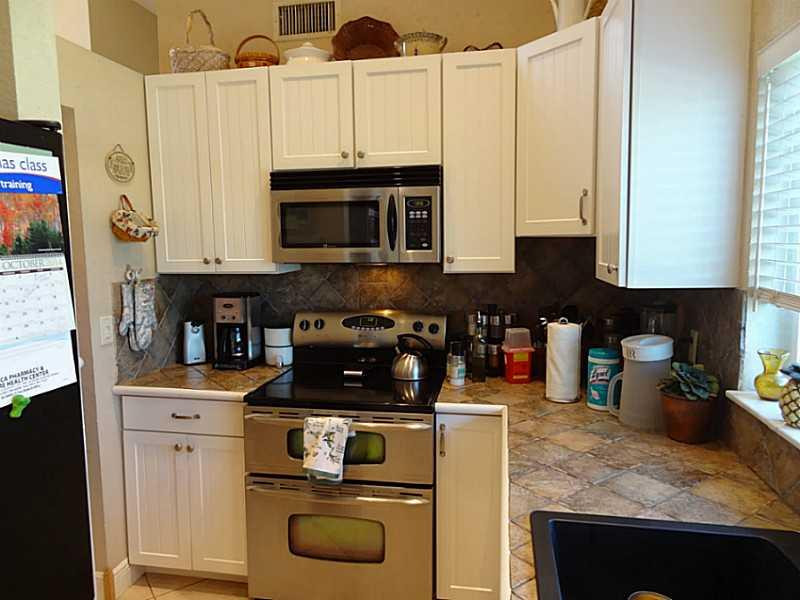 22338 Ensenada Way Boca Raton, FL 33433 - Photo 9 of 20 a kitchen with stainless steel appliances granite countertop a stove and cabinets