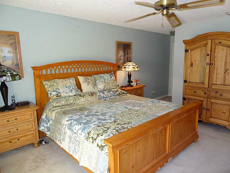 22338 Ensenada Way Boca Raton, FL 33433 - Photo 10 of 20 a bedroom with a bed and a chandelier