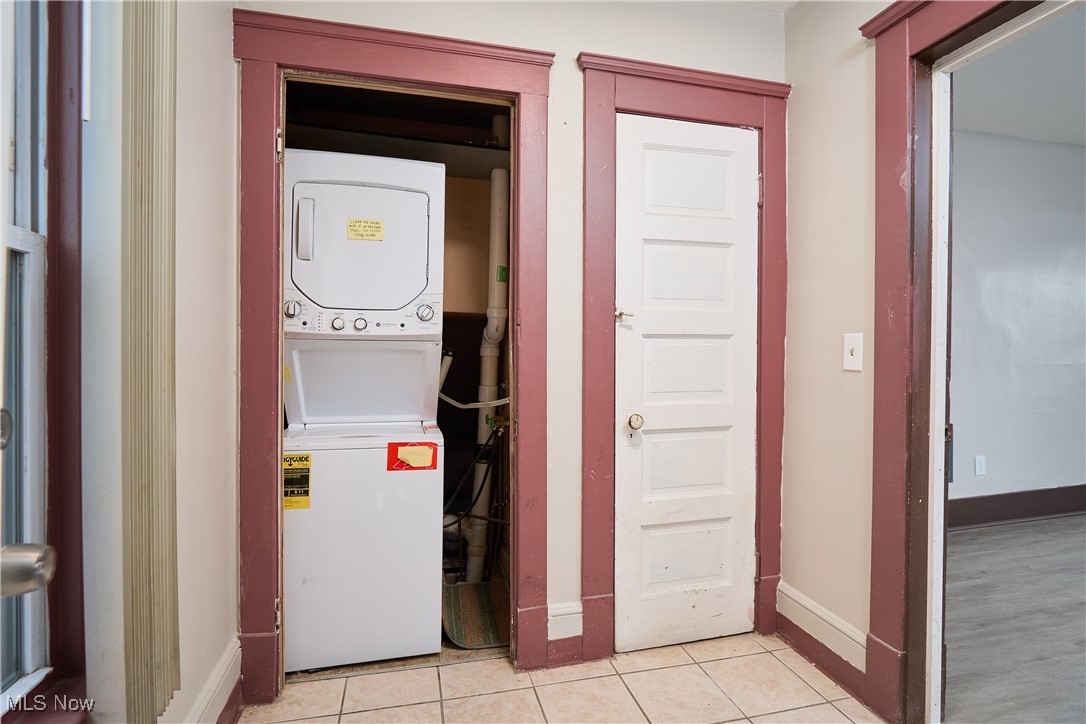 5432 State Road Parma, OH 44134 - Photo 25 of 47 Washroom with stacked washer / dryer and light tile patterned floors