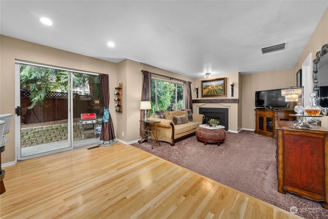 a living room with furniture tv and a fireplace