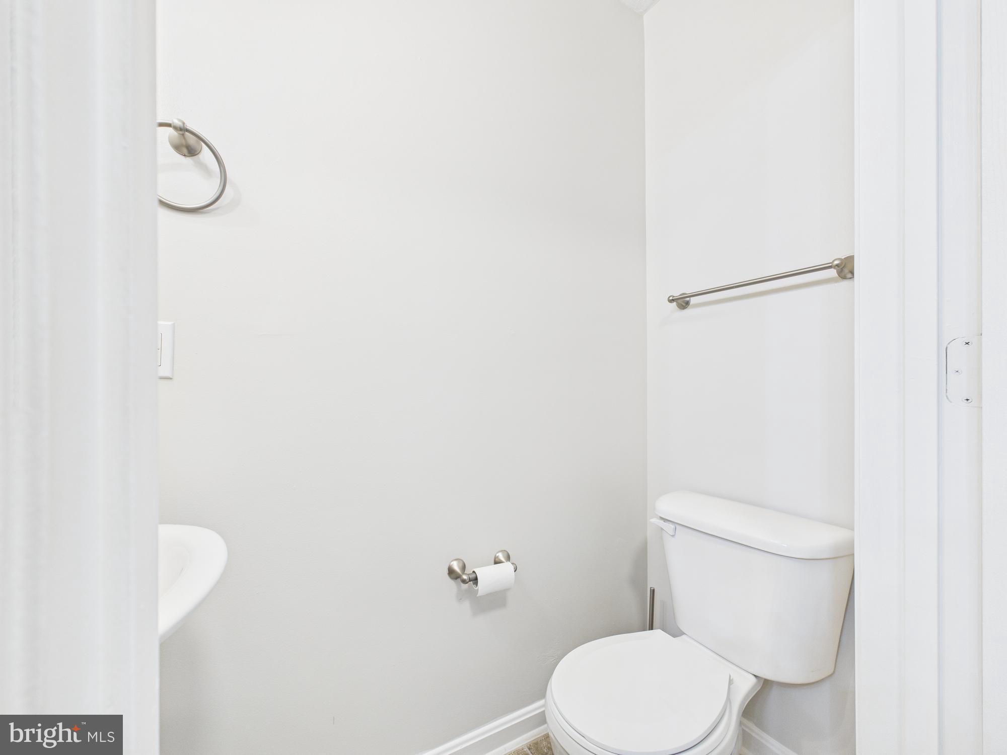 8067 Brookstone Court, Unit 100 Severn, MD 21144 - Photo 11 of 36 a white toilet sitting next to a shower