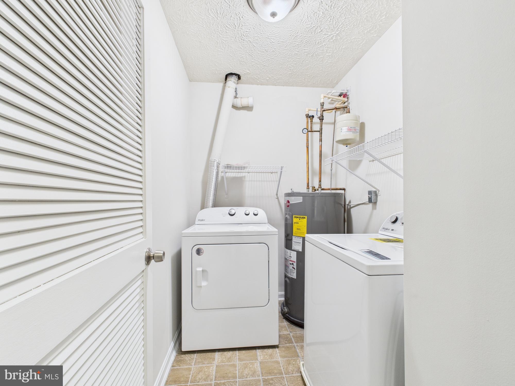8067 Brookstone Court, Unit 100 Severn, MD 21144 - Photo 14 of 36 a utility room with dryer and washer