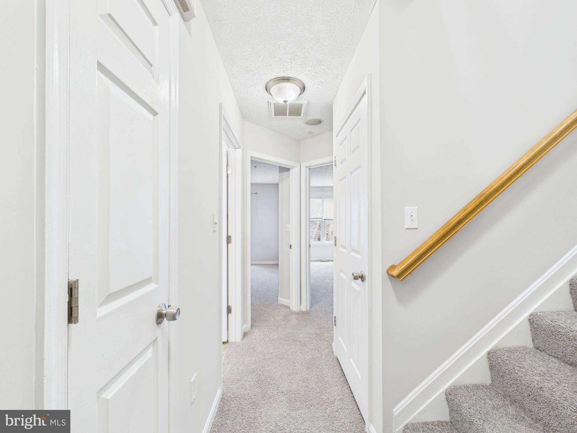 8067 Brookstone Court, Unit 100 Severn, MD 21144 - Photo 15 of 36 a view of a hallway with front door
