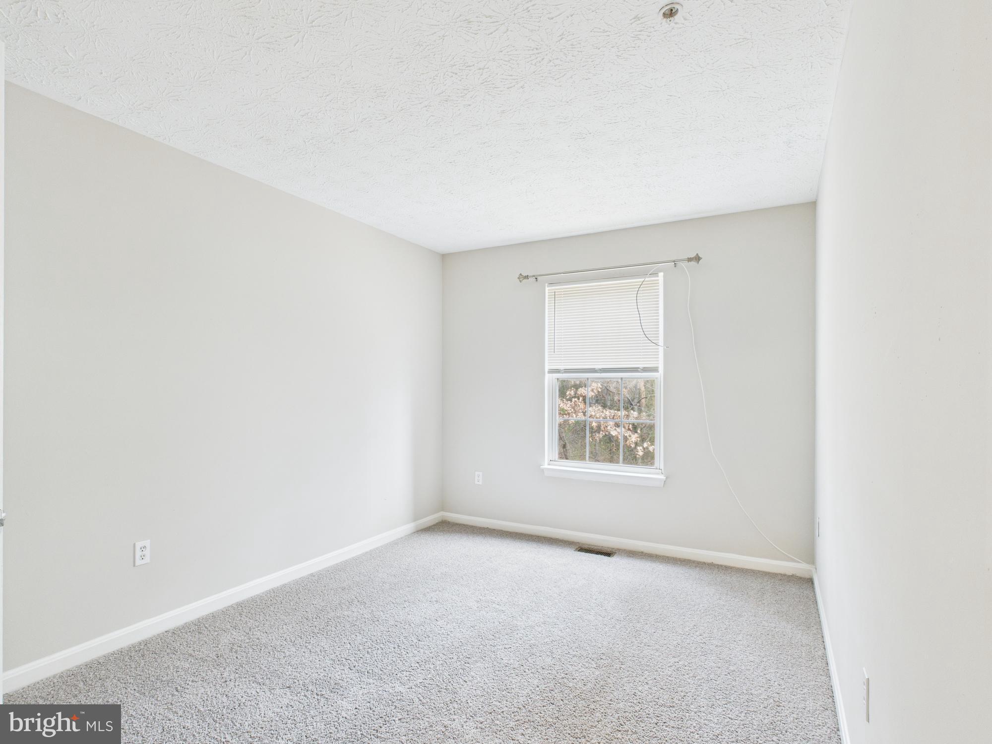 8067 Brookstone Court, Unit 100 Severn, MD 21144 - Photo 16 of 36 an empty room with a window