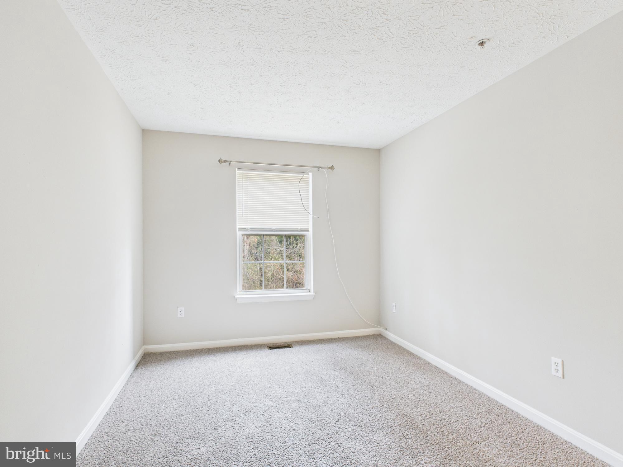 8067 Brookstone Court, Unit 100 Severn, MD 21144 - Photo 17 of 36 an empty room with a window