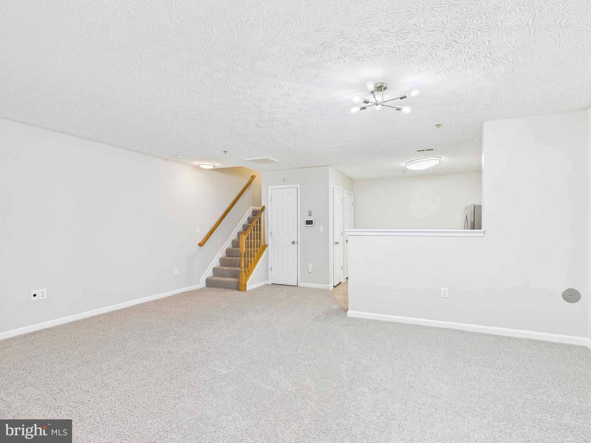8067 Brookstone Court, Unit 100 Severn, MD 21144 - Photo 2 of 36 a view of an empty room with a window