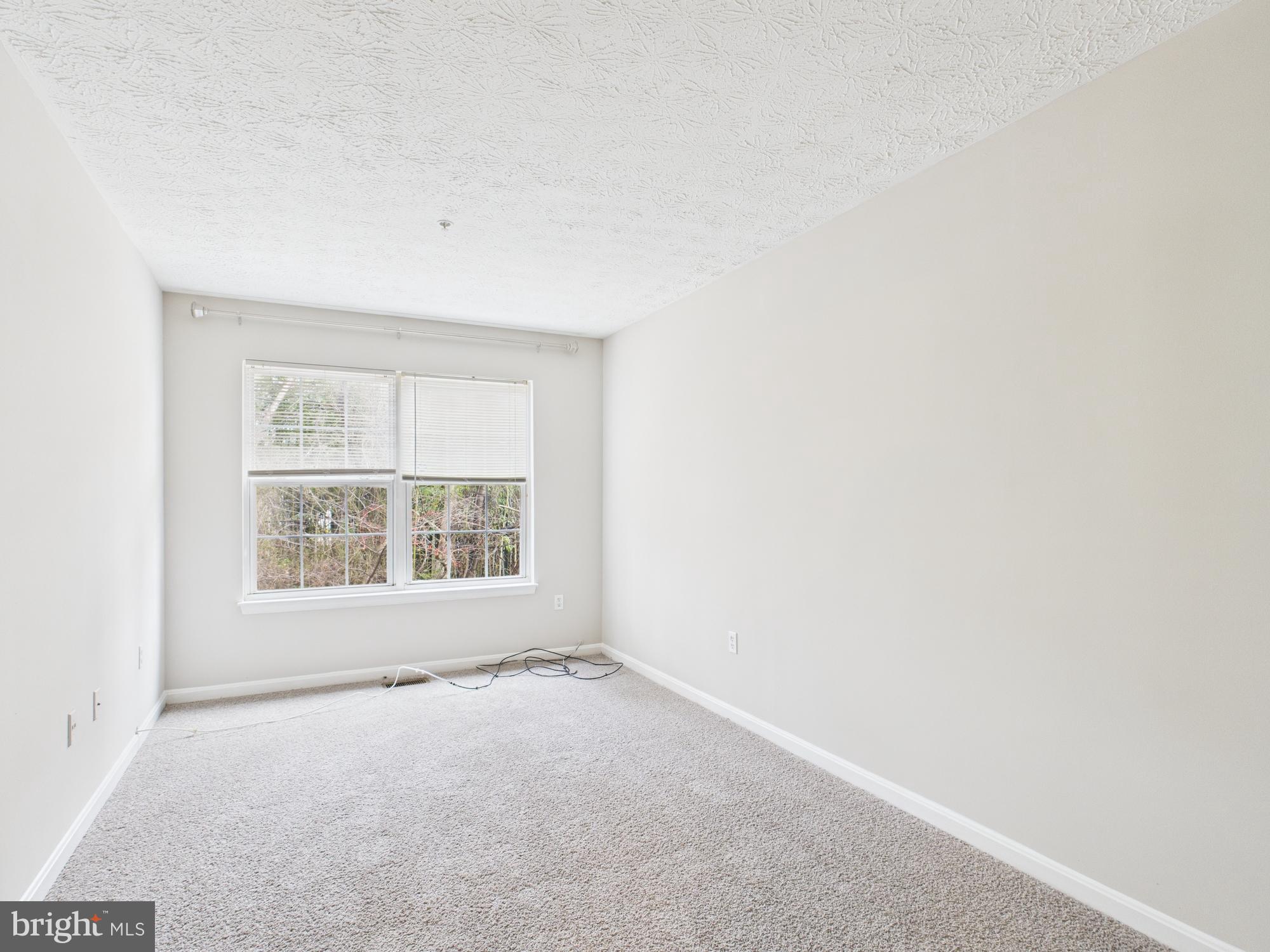 8067 Brookstone Court, Unit 100 Severn, MD 21144 - Photo 22 of 36 an empty room with a window