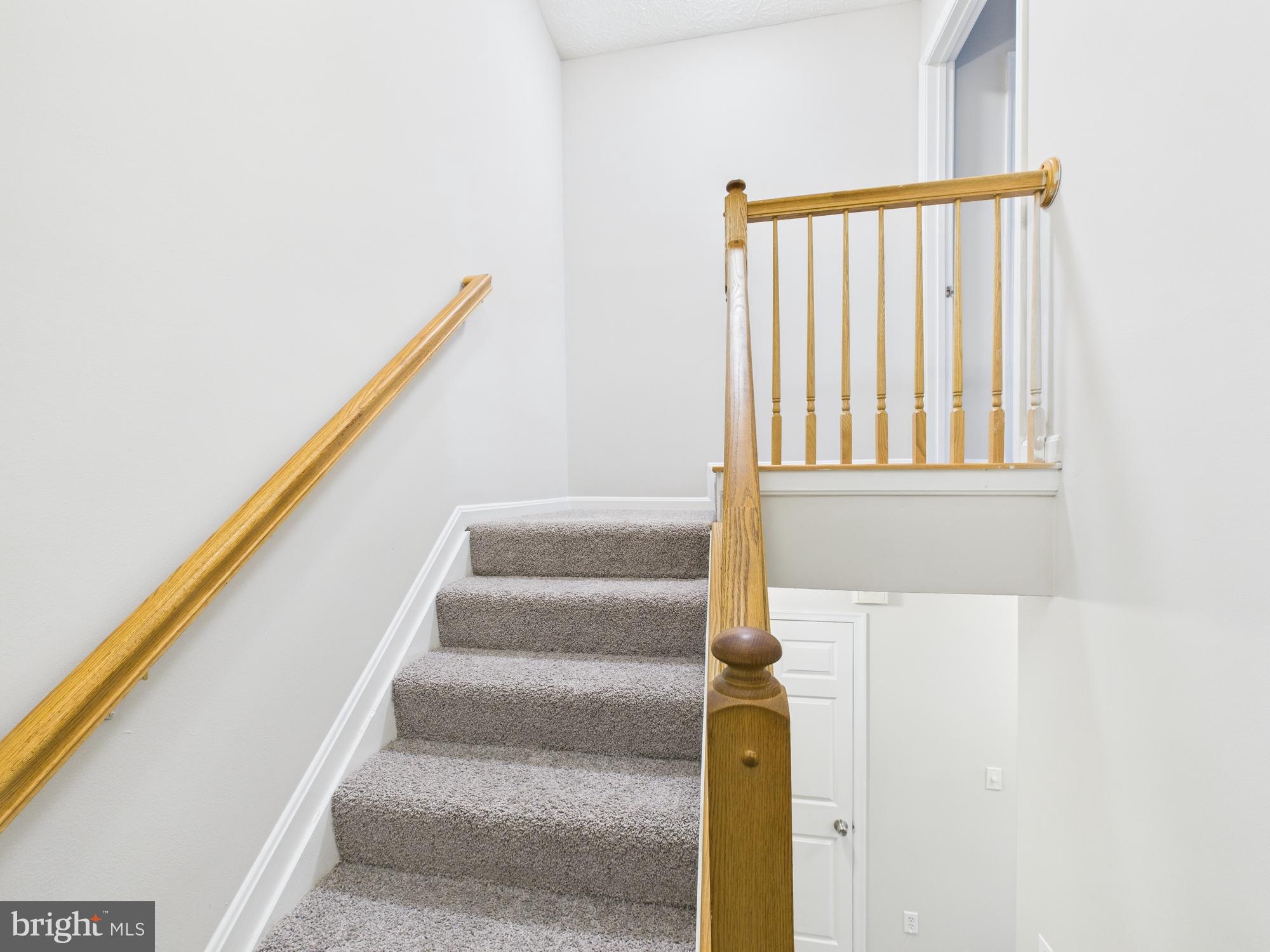 8067 Brookstone Court, Unit 100 Severn, MD 21144 - Photo 25 of 36 a view of staircase with white walls and a window