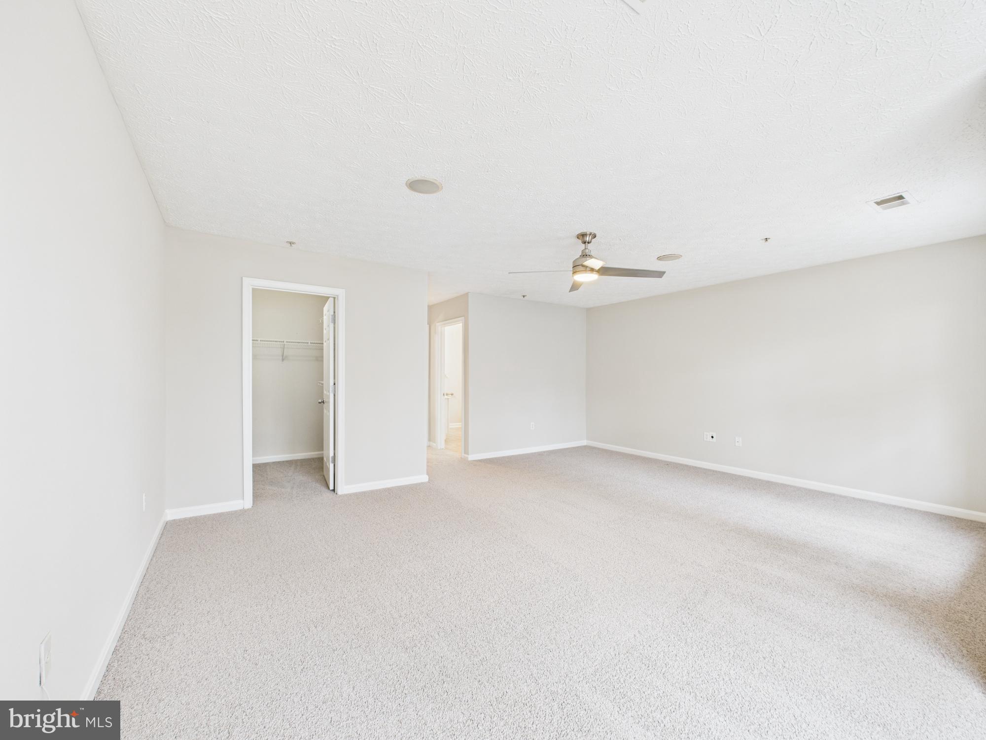 8067 Brookstone Court, Unit 100 Severn, MD 21144 - Photo 32 of 36 an empty room with a kitchen