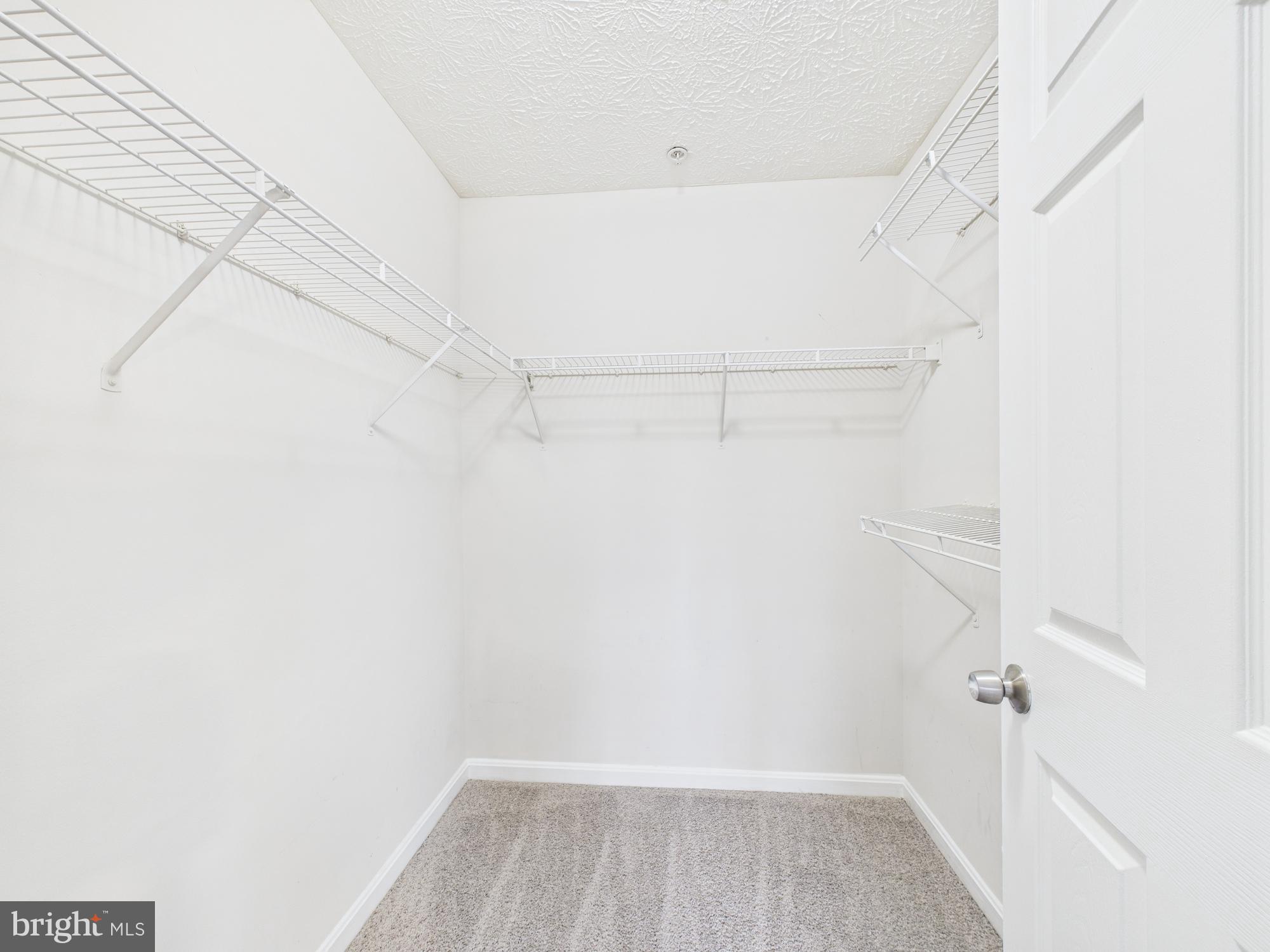 8067 Brookstone Court, Unit 100 Severn, MD 21144 - Photo 34 of 36 a view of a room with racks on the wall