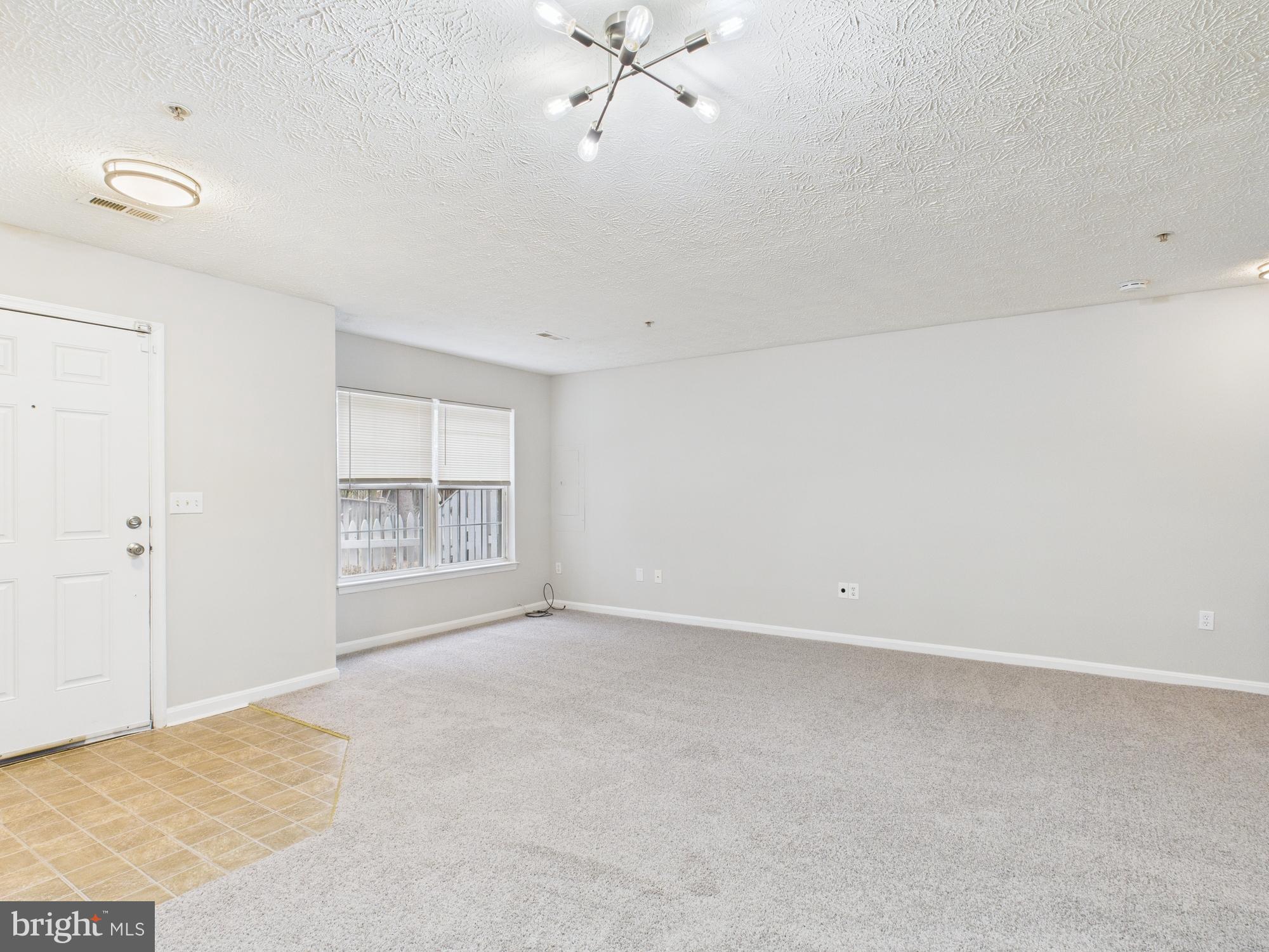 8067 Brookstone Court, Unit 100 Severn, MD 21144 - Photo 4 of 36 a view of an empty room with a window