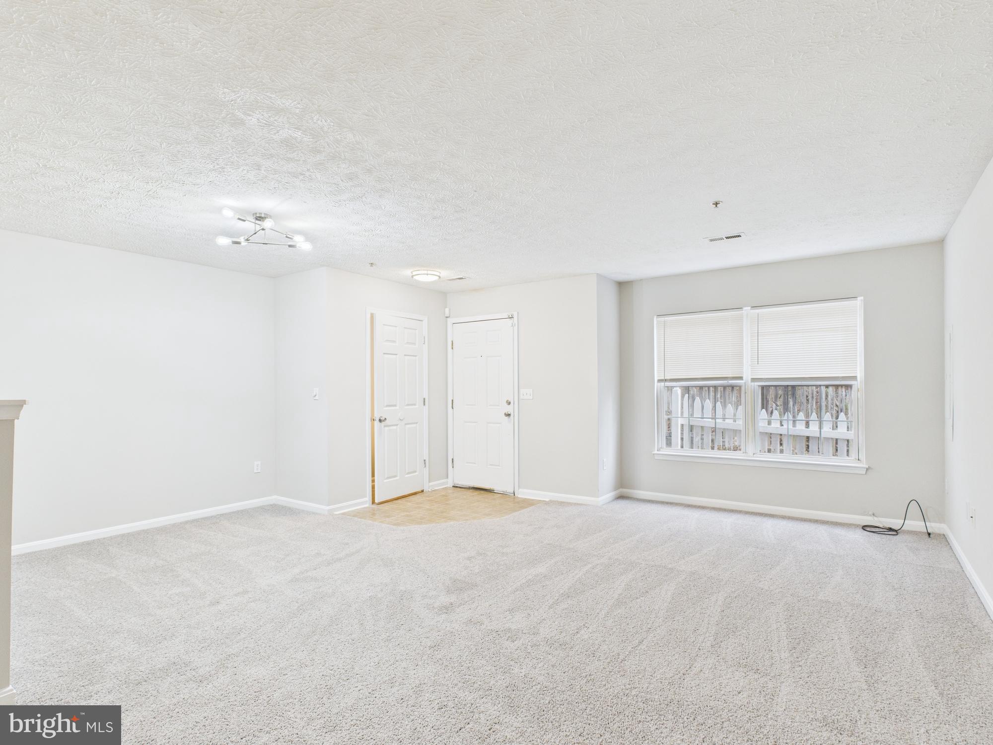 8067 Brookstone Court, Unit 100 Severn, MD 21144 - Photo 5 of 36 a view of an empty room with a window