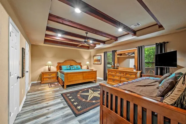 a bathroom with a granite countertop tub sink and mirror