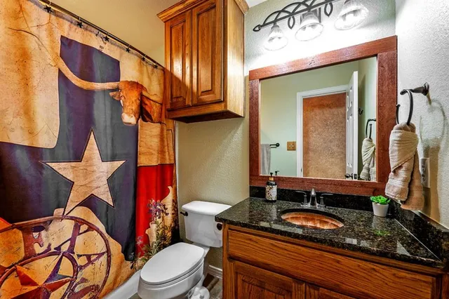 a bathroom with a granite countertop sink and a blue dryer