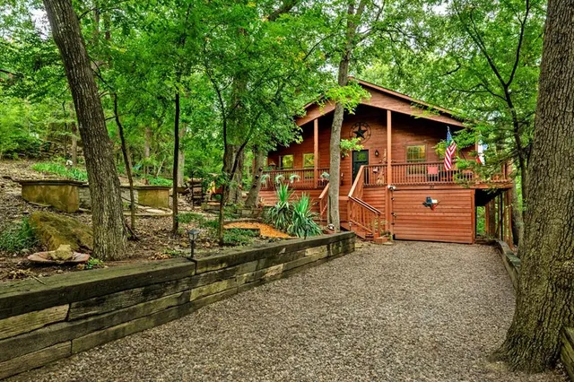 a view of a chairs and table on the wooden roof deck