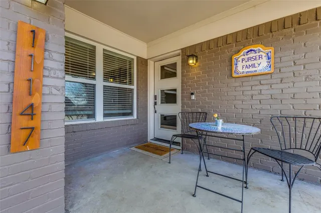 a backyard of a house with barbeque oven table and chairs