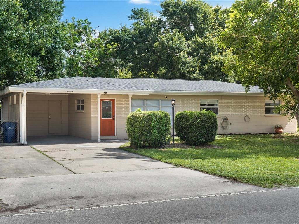 3715 Wilkinson Road Sarasota, FL 34233 - Photo 1 of 1 a house with a tree in front of it