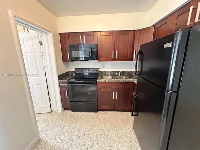 a kitchen with a refrigerator stove and sink