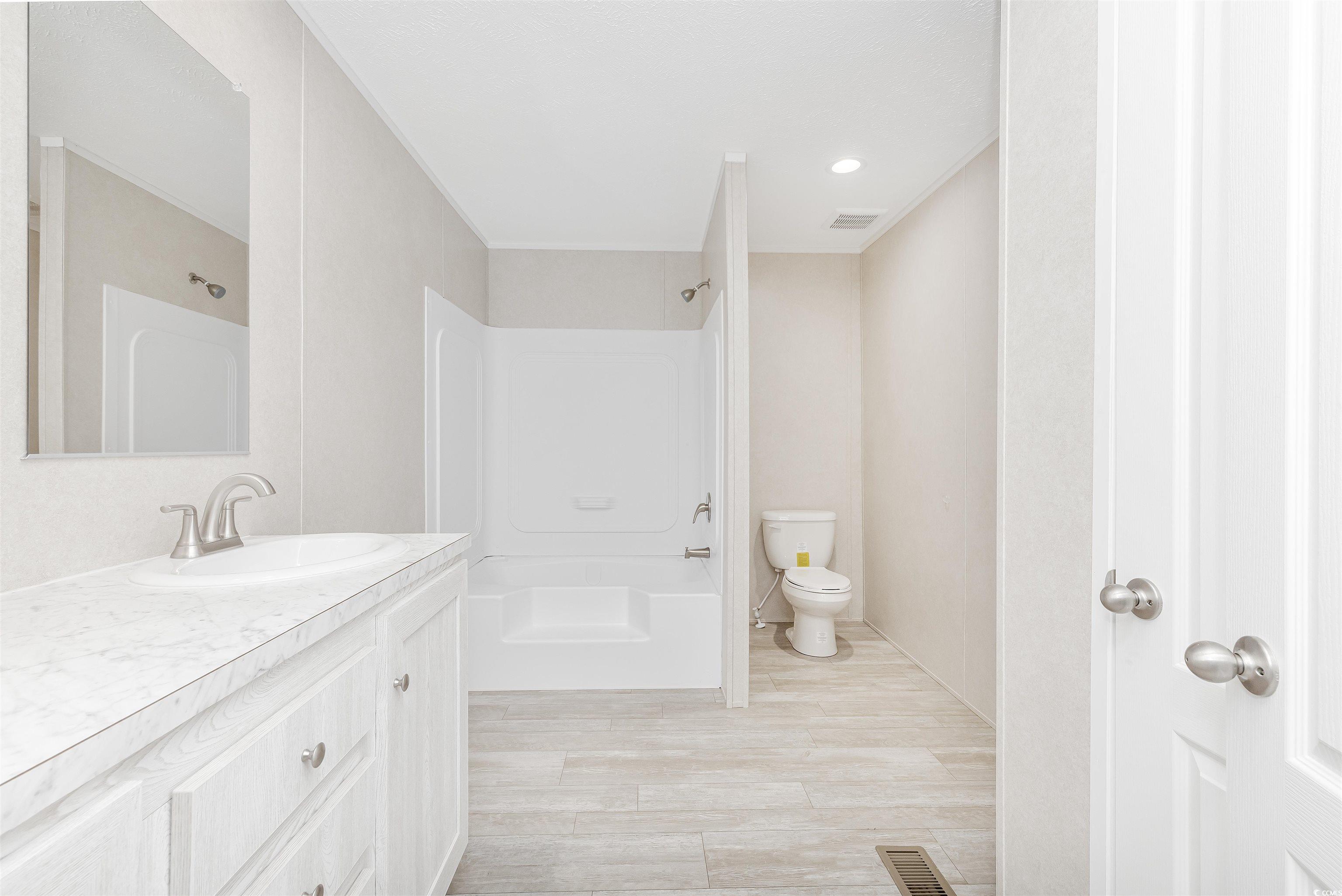398 West Canal Street Murrells Inlet, SC 29576 - Photo 18 of 40 Full bathroom with vanity, toilet, washtub / showe