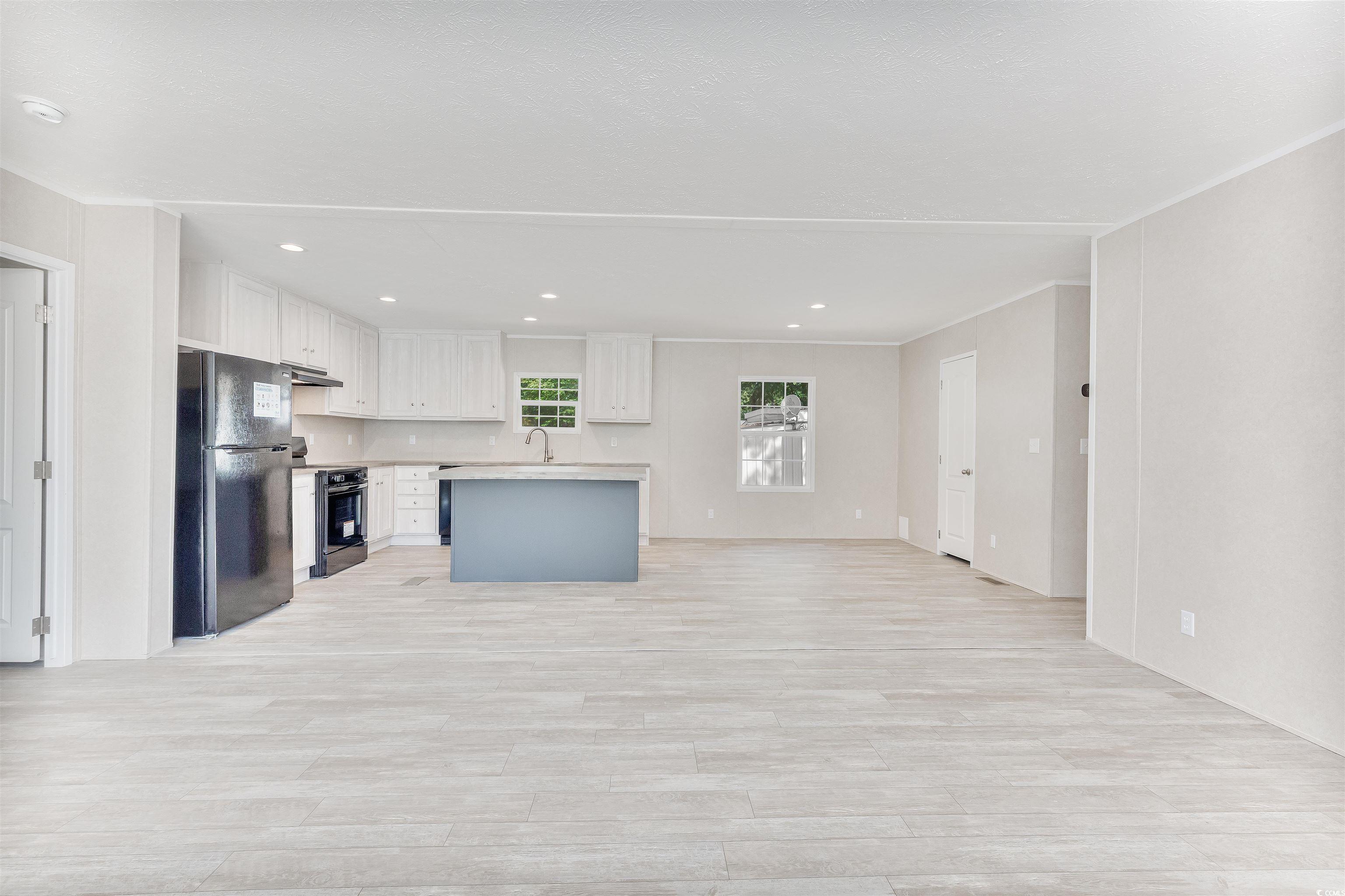 398 West Canal Street Murrells Inlet, SC 29576 - Photo 7 of 40 Kitchen featuring a kitchen island, sink, black ap