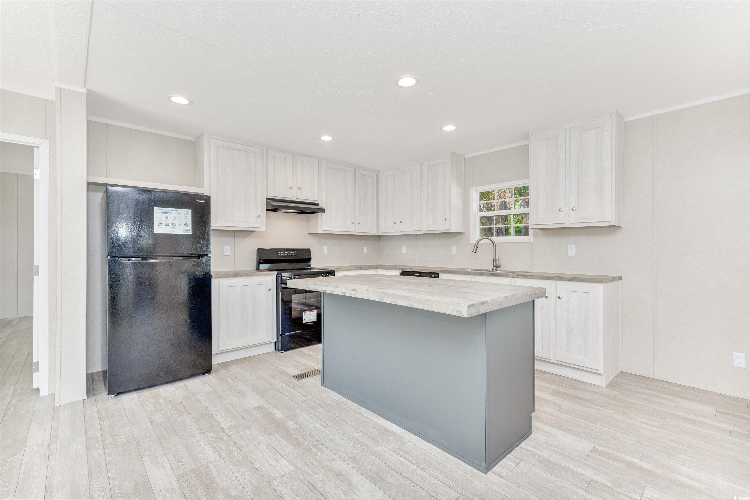 398 West Canal Street Murrells Inlet, SC 29576 - Photo 9 of 40 Kitchen with black appliances, white cabinets, lig