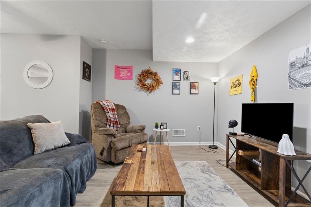 403 Ormsby Avenue Pittsburgh, PA 15210 - Photo 11 of 32 a living room with furniture and a flat screen tv