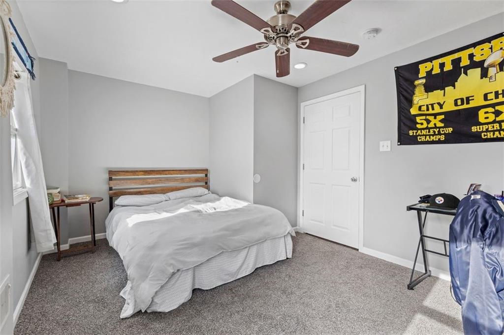403 Ormsby Avenue Pittsburgh, PA 15210 - Photo 13 of 32 a bedroom with a bed and ceiling fan