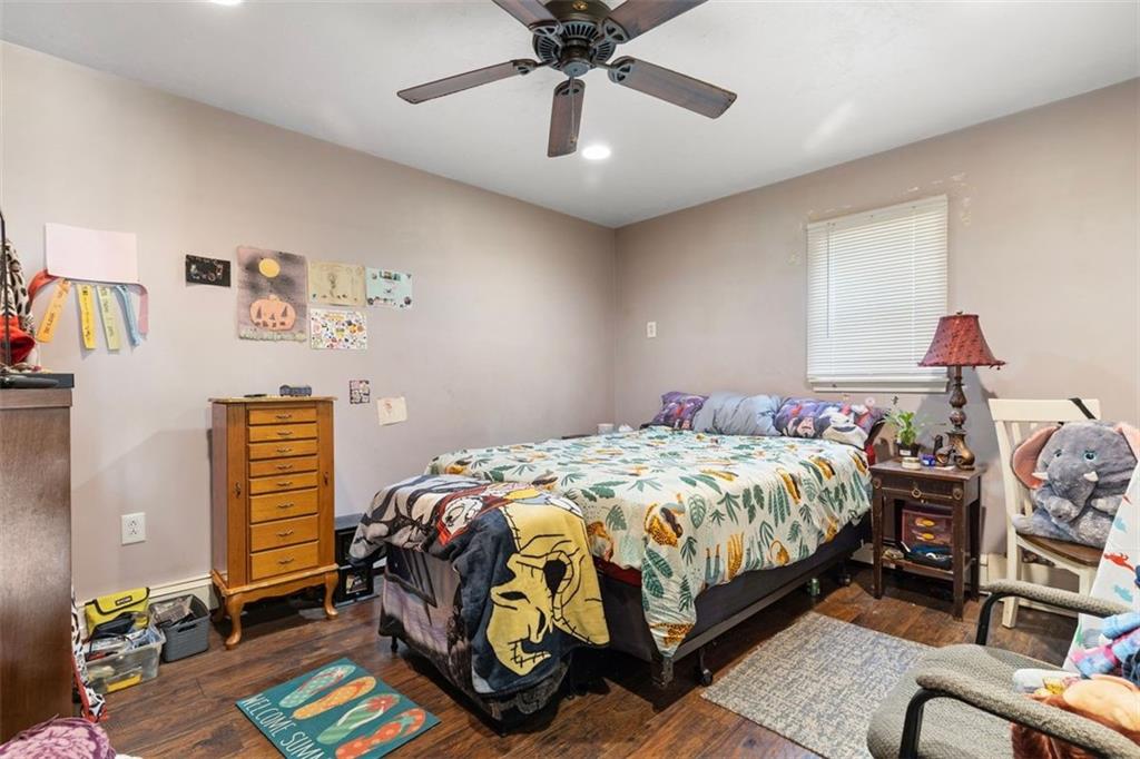 403 Ormsby Avenue Pittsburgh, PA 15210 - Photo 26 of 32 a bedroom with bed and a chandelier