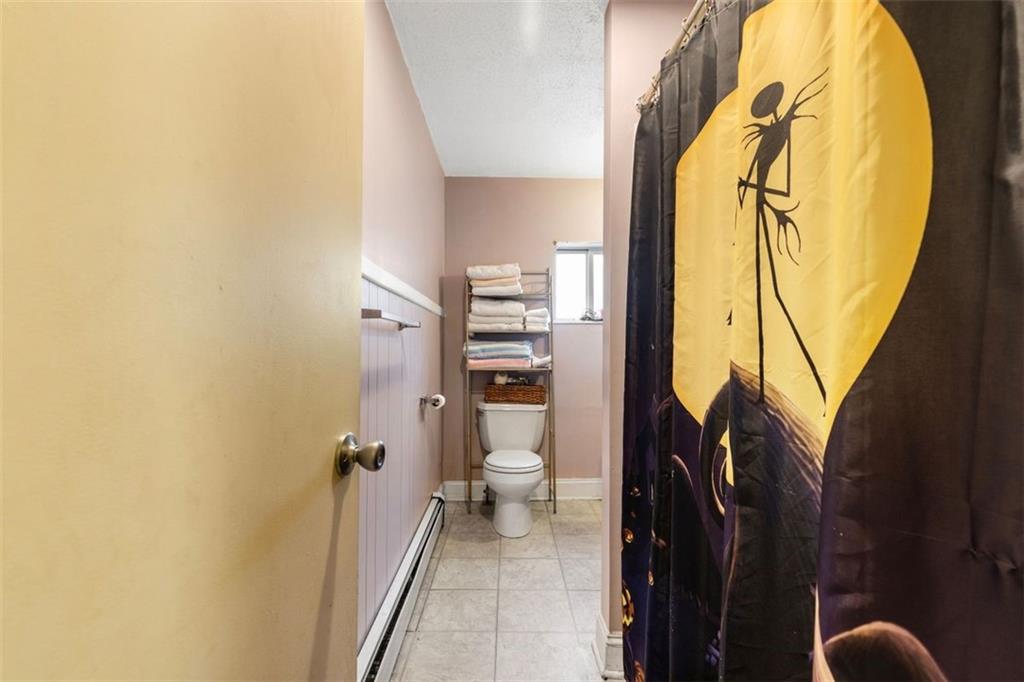 403 Ormsby Avenue Pittsburgh, PA 15210 - Photo 27 of 32 a bathroom with a granite countertop sink and a mirror
