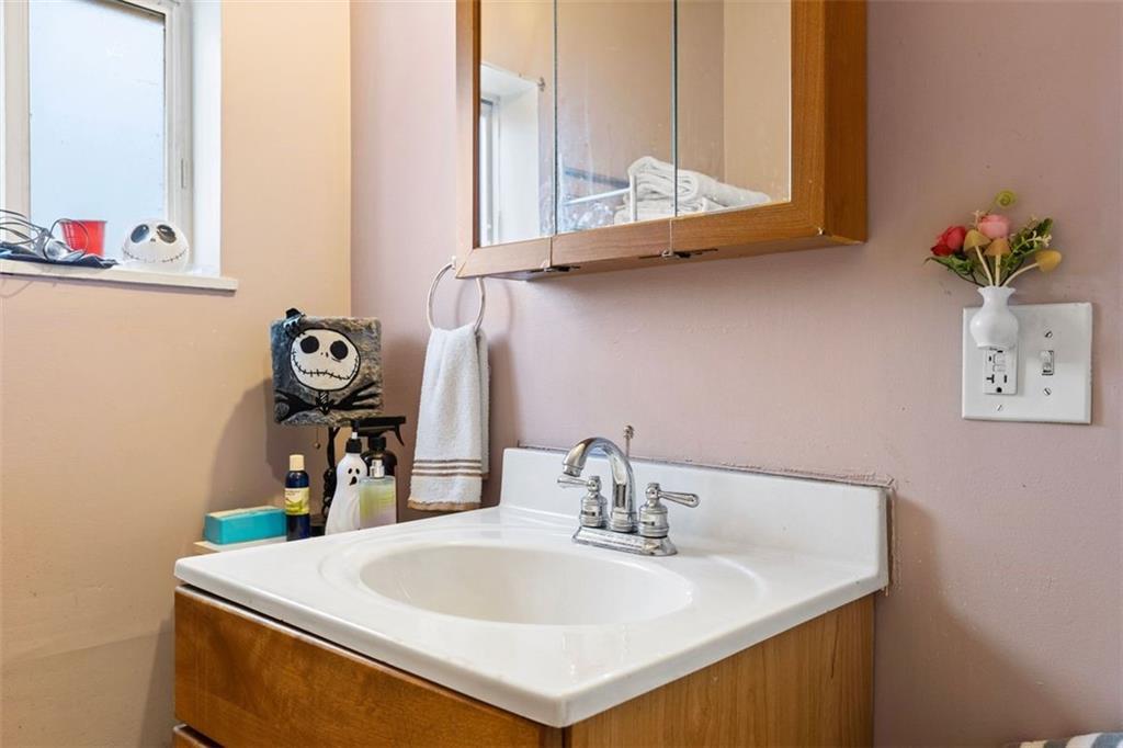403 Ormsby Avenue Pittsburgh, PA 15210 - Photo 28 of 32 a bathroom with a sink and a mirror