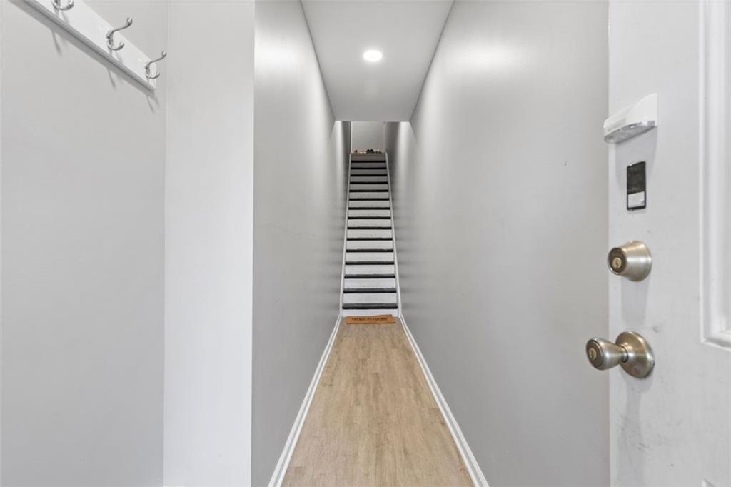 403 Ormsby Avenue Pittsburgh, PA 15210 - Photo 5 of 32 a view of a hallway with stairs and wooden floor