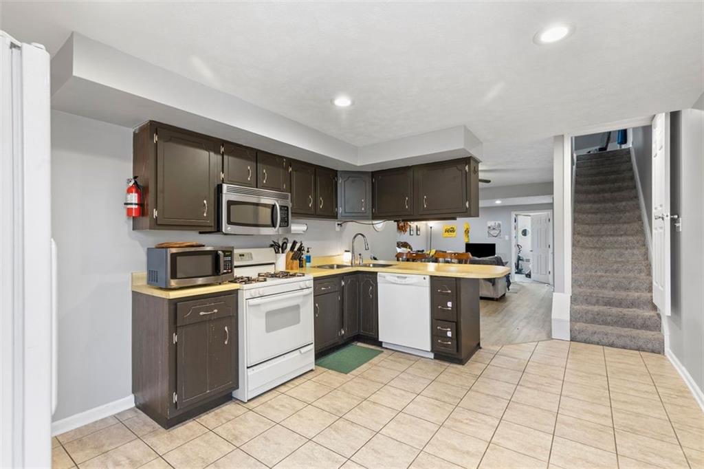 403 Ormsby Avenue Pittsburgh, PA 15210 - Photo 8 of 32 a kitchen with stainless steel appliances granite countertop a refrigerator and a stove top oven