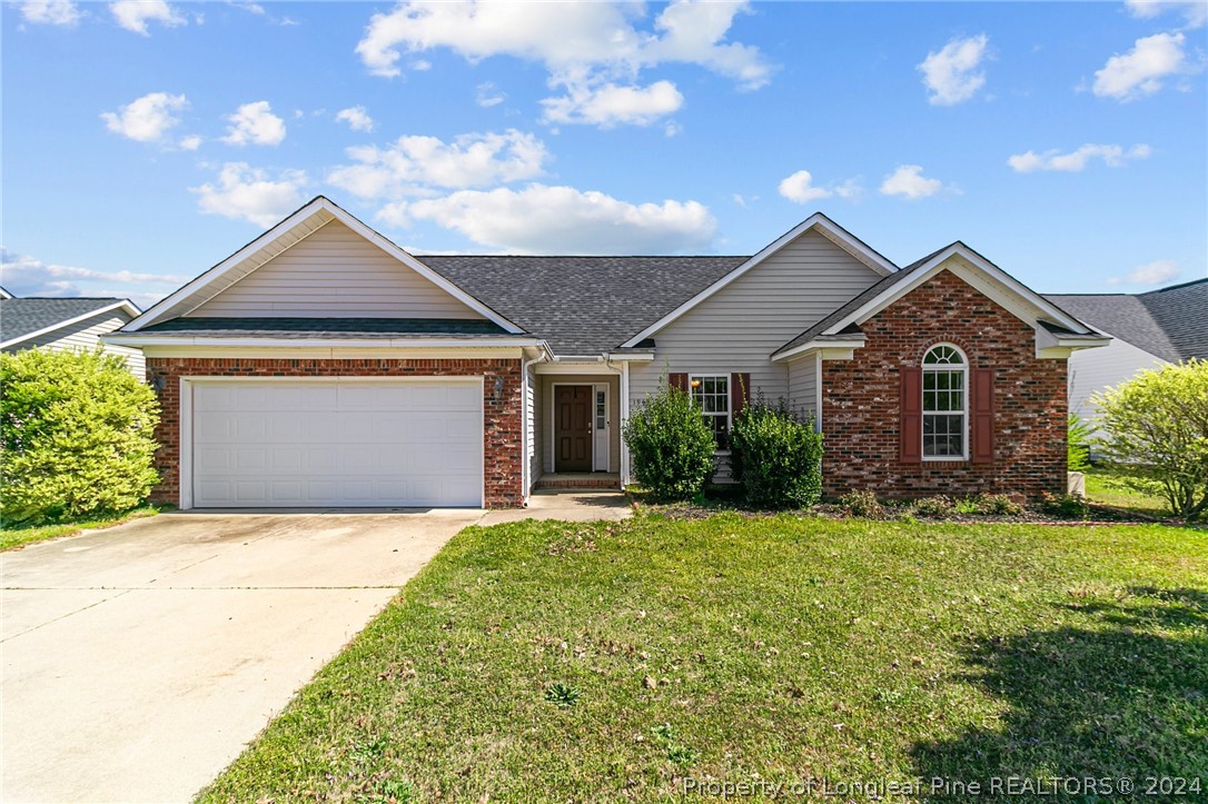 a front view of a house with yard and garage