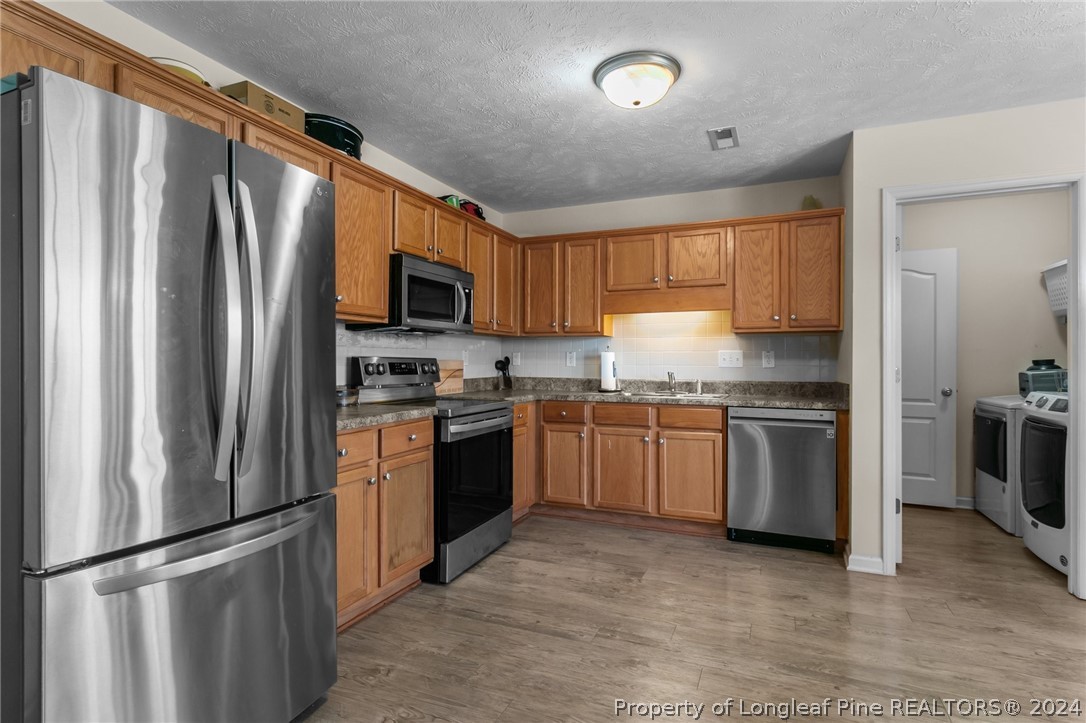 1949 Yellowbrick Road Fayetteville, NC 28314 - Photo 15 of 34 a kitchen with granite countertop stainless steel appliances and refrigerator