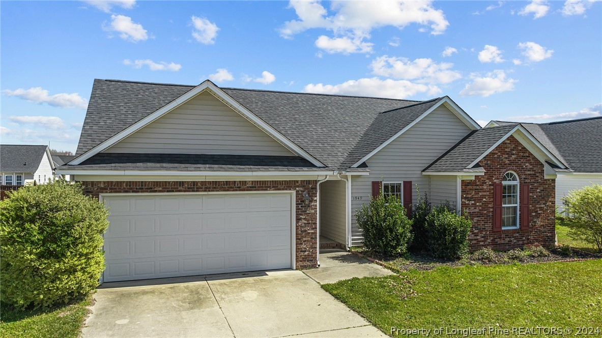 1949 Yellowbrick Road Fayetteville, NC 28314 - Photo 2 of 34 a front view of a house with a garden