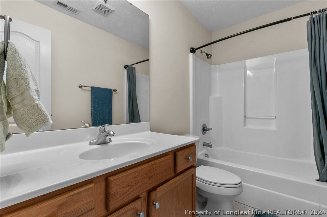 1949 Yellowbrick Road Fayetteville, NC 28314 - Photo 21 of 34 a bathroom with a sink toilet and shower