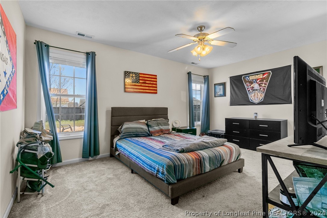 1949 Yellowbrick Road Fayetteville, NC 28314 - Photo 22 of 34 a bedroom with a bed and a chandelier