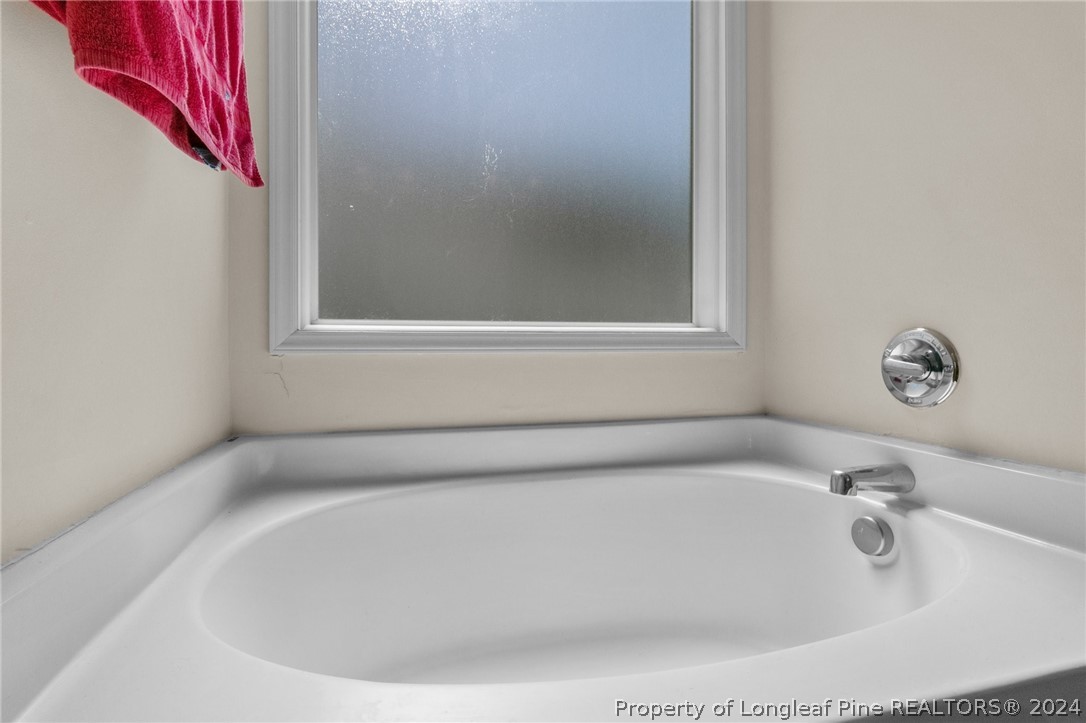 1949 Yellowbrick Road Fayetteville, NC 28314 - Photo 25 of 34 a white bath tub sitting in a bathroom
