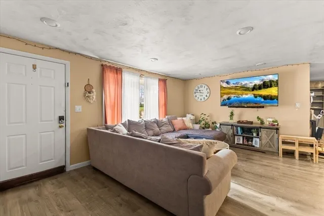 a living room with furniture wooden floor and window
