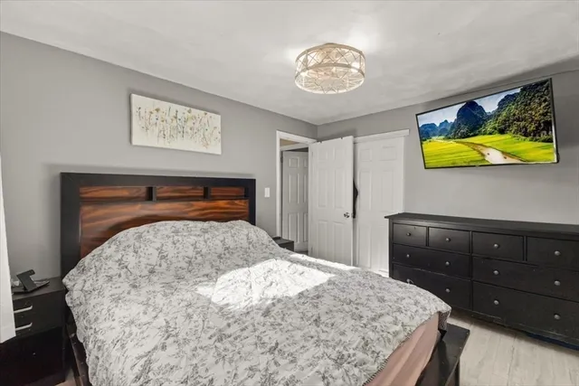 a bedroom with a bed and a dresser