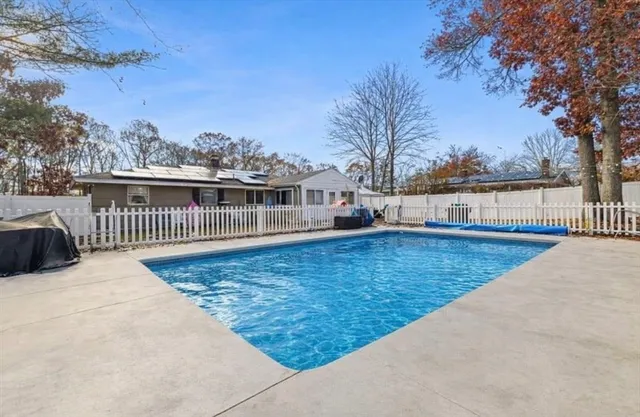 a view of a house with wooden fence